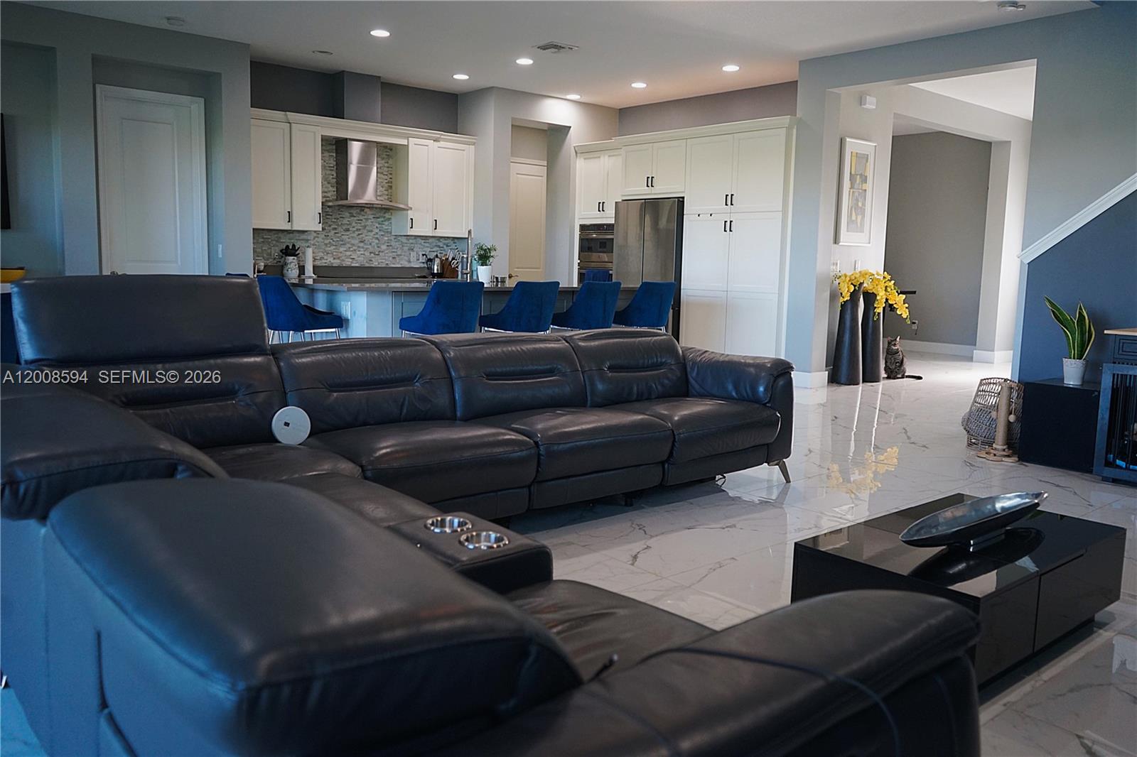 A two-story house with a three-car garage and a paved driveway under a cloudy sky — 5850 Whippoorwill Cir, Westlake FL 33470, WESTLAKE, FL