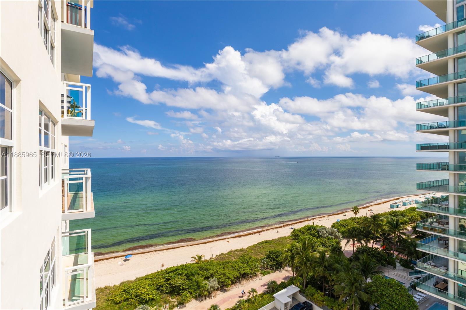 An elevated view shows a swimming pool, lounge chairs, and palm trees beside a beach — 6917 Collins Ave # 1505, Miami Beach FL 33141, MIAMI BEACH, FL