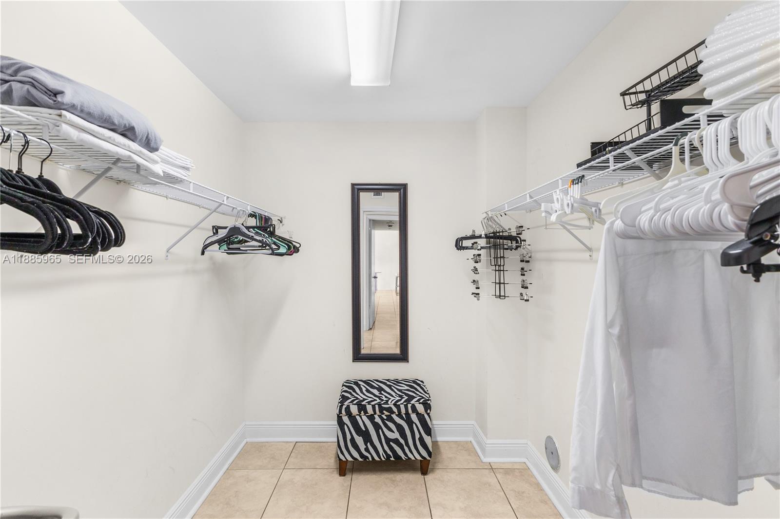 A kitchen features stainless steel appliances, light wood cabinets, and black granite countertops — 6917 Collins Ave # 1505, Miami Beach FL 33141, MIAMI BEACH, FL