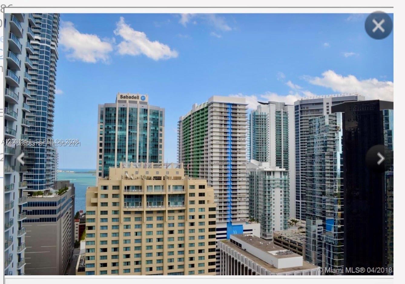 An elevated view of several high-rise apartment buildings and a hotel in a city — MIAMI, FL