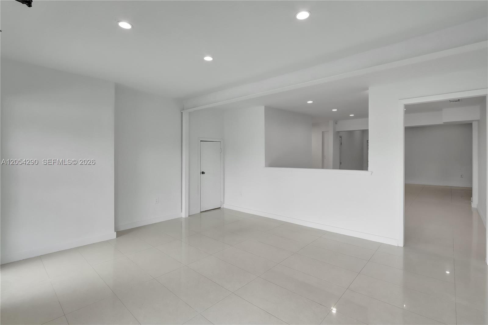 A bright, empty room features white walls, recessed ceiling lights, and light-colored tiled flooring — 7000 NW 2 Ave # 7010, Miami FL 33150, MIAMI, FL