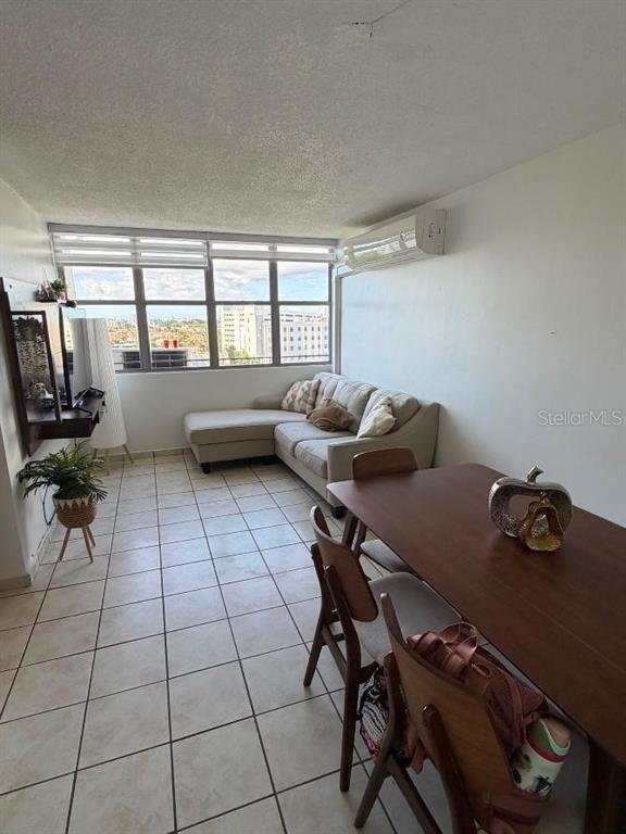 A living and dining area features tile flooring, a sectional sofa, and a wooden table — 1785 COND MILLENIA PARK UNIT 14, SAN JUAN, PR
