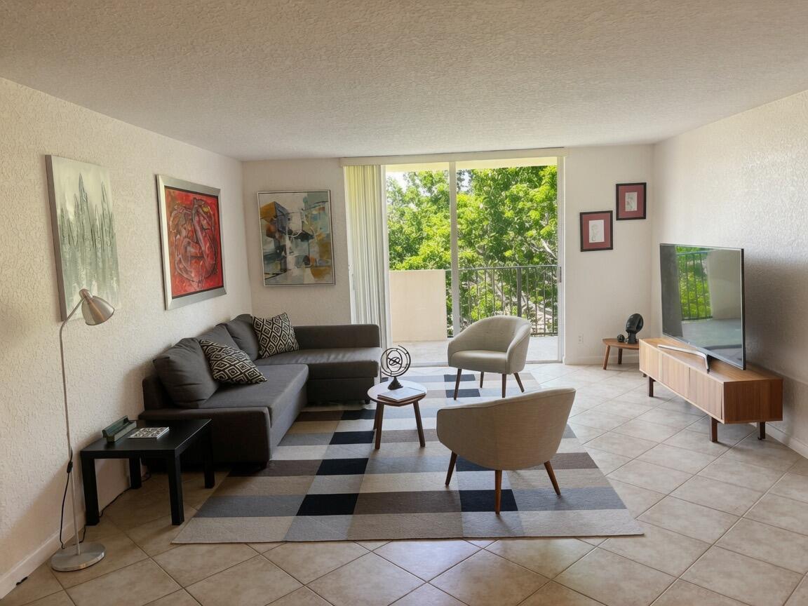 A living room features a sectional sofa, two armchairs, a geometric rug, and a balcony view — 1000 Spanish River Road # 4p, Boca Raton FL 33432, BOCA RATON, FL