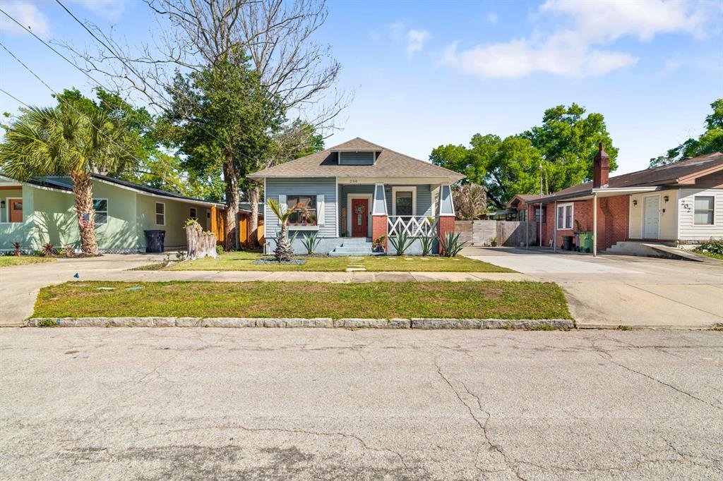 A single-story house with gray siding, a front porch, and a paved driveway — 200 E FERN STREET, TAMPA, FL