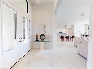 A bright entryway with marble floors leads into an open-concept living area and kitchen — 229 NW 33RD AVENUE, CAPE CORAL, FL