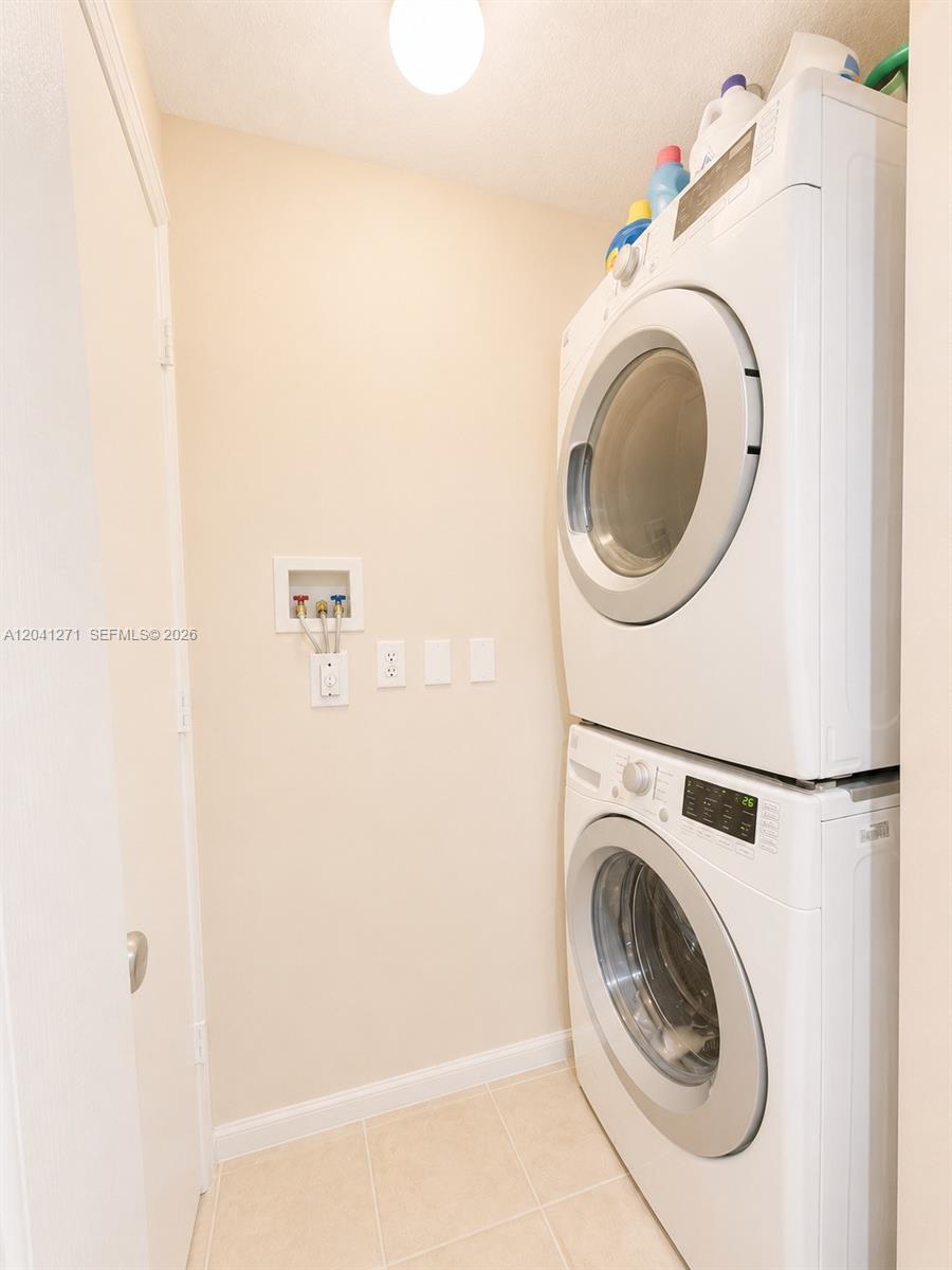 A laundry closet contains a stacked white washer and dryer unit — 6670 NW 114th Ave # 603, Doral FL 33178, DORAL, FL