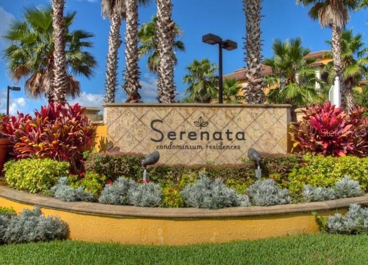 A stone monument sign for Serenata condominium residences sits in front of palm trees and landscaping — 8325 38TH STREET CIRCLE E UNIT 102, SARASOTA, FL