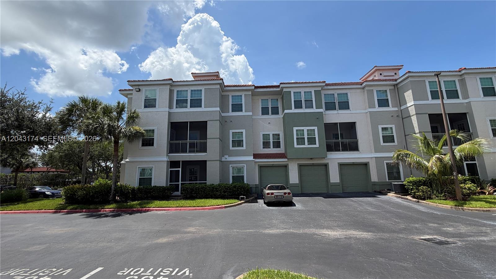 A three-story apartment building with a parking lot and a parked car in front — 23500 Walden Center Dr # 210, Estero FL 34134, ESTERO, FL