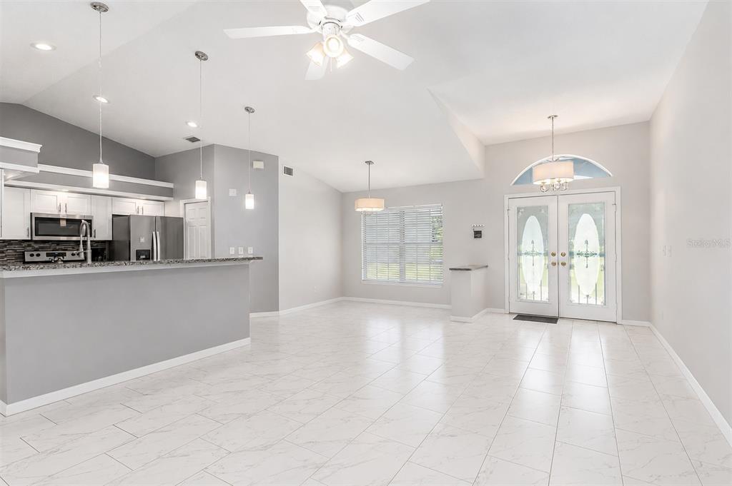 An aerial view shows a house with a solar panel array and a backyard pool — 9105 S ZANMAR DRIVE, FLORAL CITY, FL