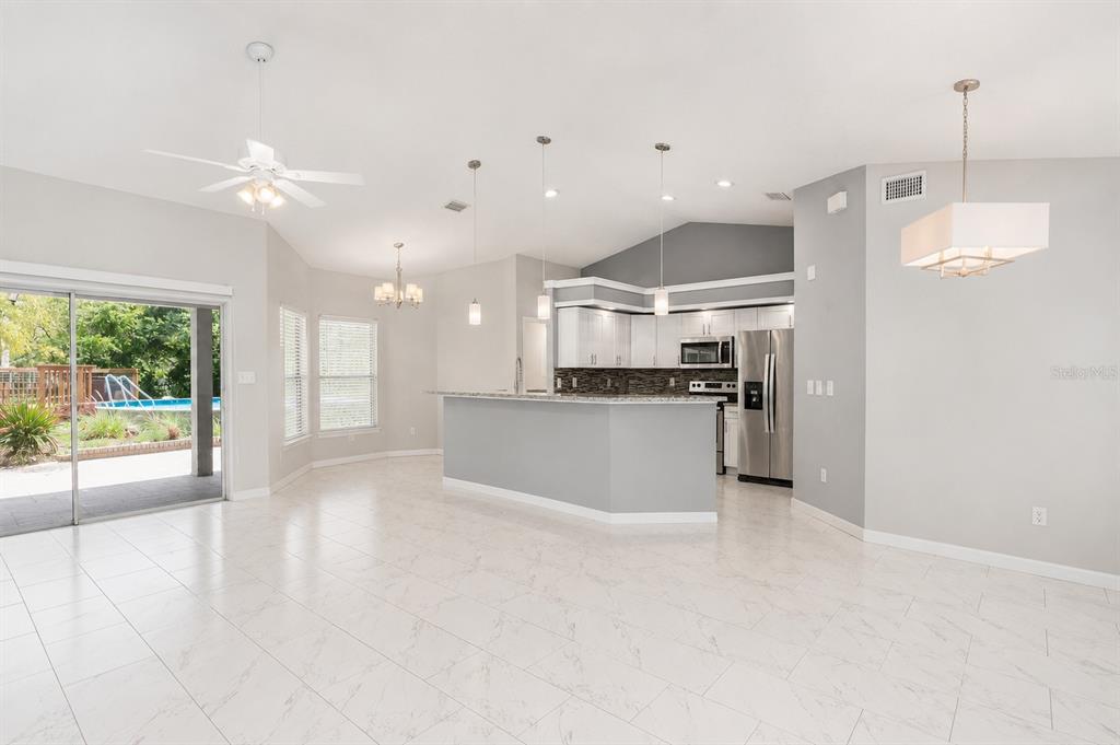 A circular above-ground swimming pool sits next to a wooden deck and brick patio — 9105 S ZANMAR DRIVE, FLORAL CITY, FL