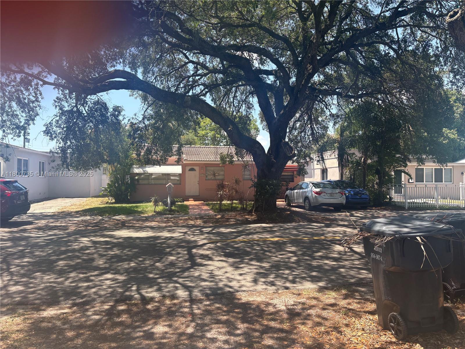 A single-story house with a large tree in the front yard and parked cars — 2530 Washington St, Hollywood FL 33020, HOLLYWOOD, FL
