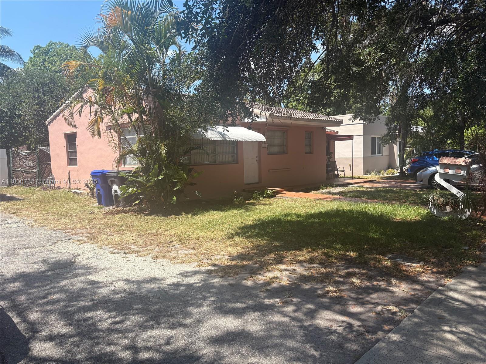 A single-story peach-colored house with a metal awning sits behind a palm tree and lawn — 2530 Washington St, Hollywood FL 33020, HOLLYWOOD, FL