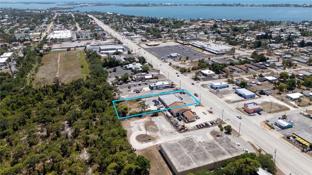An aerial view shows a commercial property outlined in blue along a main road — 119 S INDIANA AVENUE, ENGLEWOOD, FL