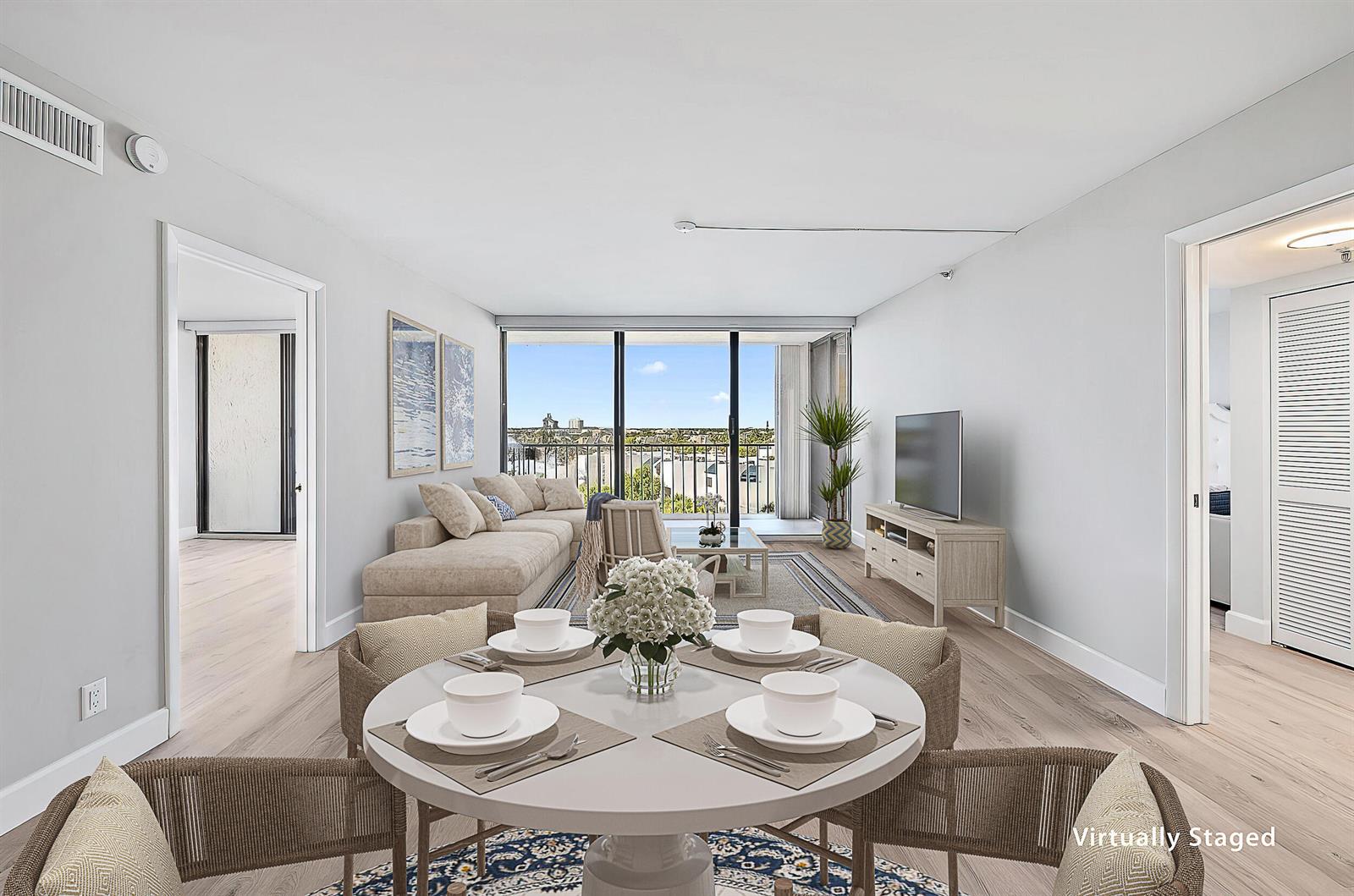 This virtually staged living and dining area features light wood floors and a balcony view — 1300 S Highway A1a # 523, Jupiter FL 33477, JUPITER, FL