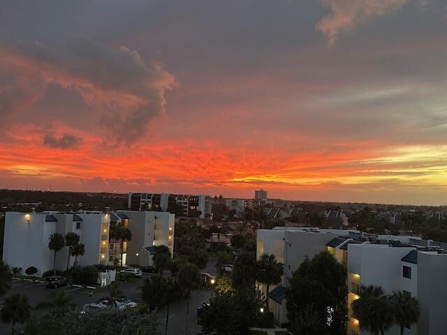 An elevated view of apartment buildings at sunset with a vibrant orange and red sky — 1300 S Highway A1a # 523, Jupiter FL 33477, JUPITER, FL