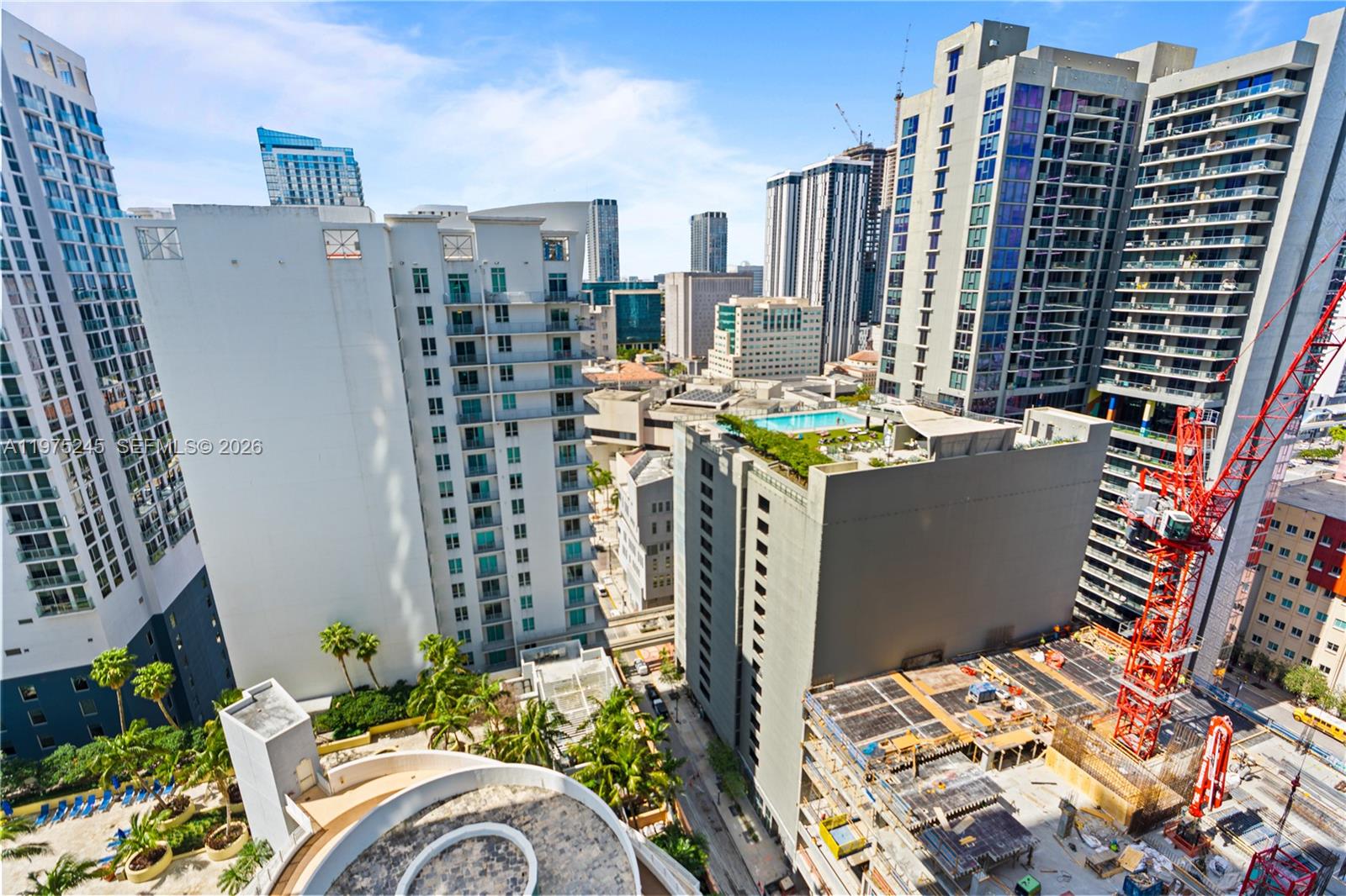 An elevated view shows a dense urban cityscape with high-rise buildings and a construction site — 244 Biscayne Blvd # 2410, Miami FL 33132, MIAMI, FL