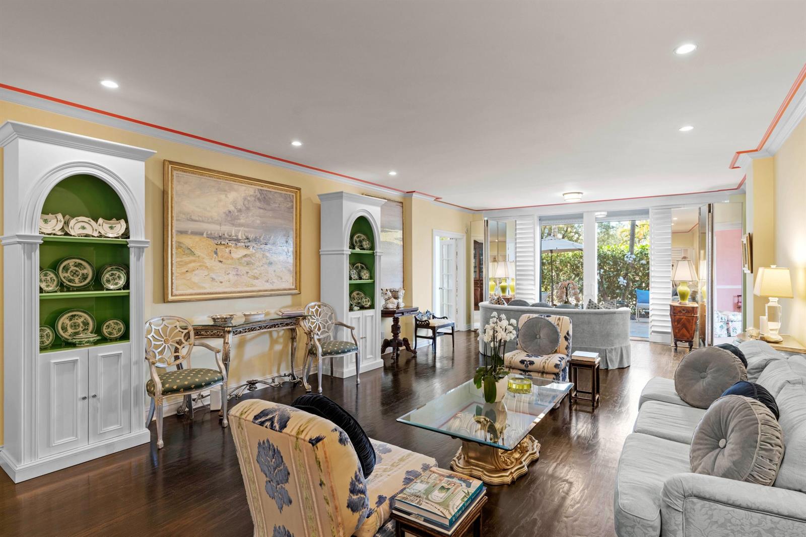 A living room features light yellow walls, dark hardwood floors, white arched shelving, and furniture — 315 S Lake Drive # 1a, Palm Beach FL 33480, PALM BEACH, FL