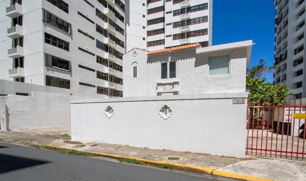A white stucco house with a tiled roof stands behind a walled courtyard — 1403 CONVENIENCIA STREET, SAN JUAN, PR