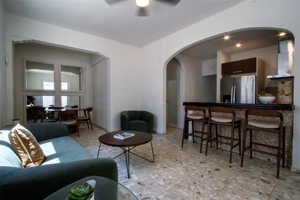 A living room with tile floors, a sofa, a coffee table, and an open kitchen — 1403 CONVENIENCIA STREET, SAN JUAN, PR