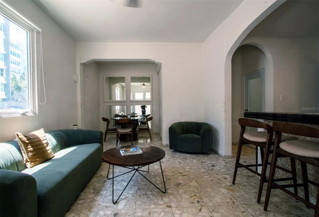 A living room features a green sofa, a round coffee table, and a dining area — 1403 CONVENIENCIA STREET, SAN JUAN, PR