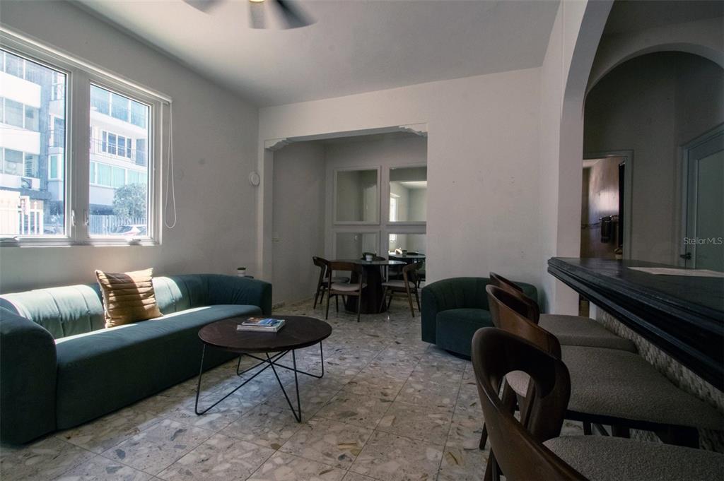 A living room with a green sofa, round coffee table, and terrazzo flooring — 1403 CONVENIENCIA STREET, SAN JUAN, PR