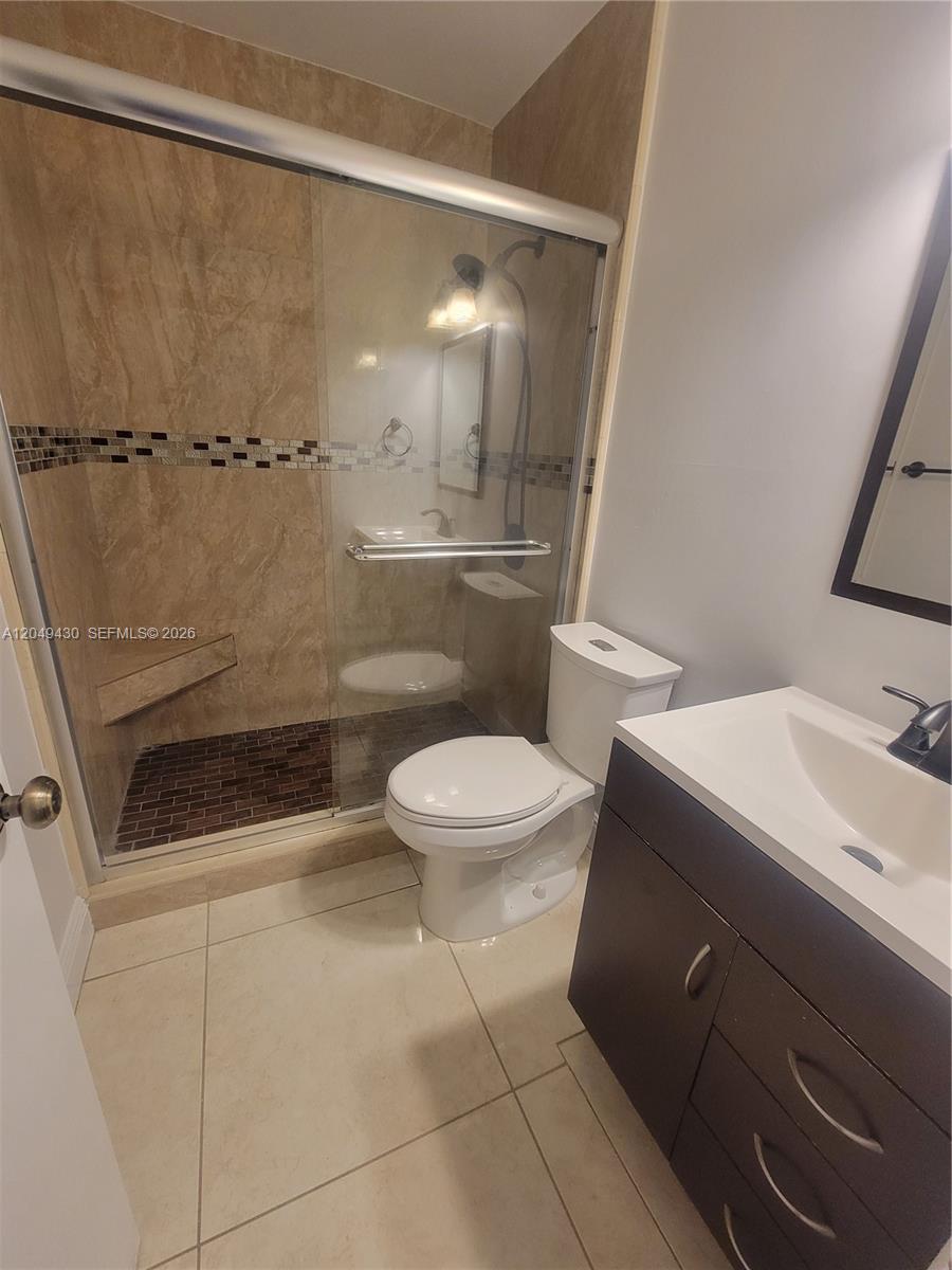 A kitchen features light wood-grain cabinets, stainless steel appliances, and black countertops — 3504 NW 111th Ave # 3504, Sunrise FL 33351, SUNRISE, FL
