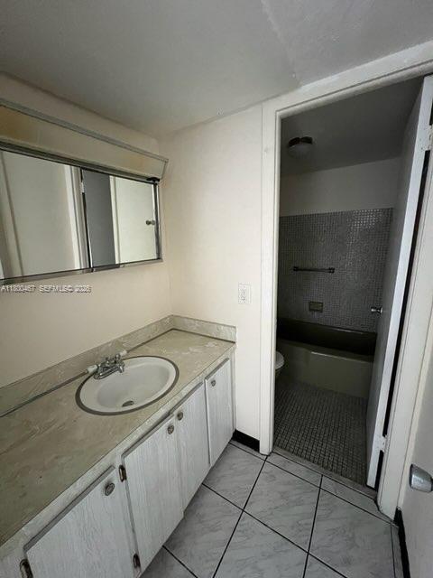 A bathroom features a vanity with a sink, a wall mirror, and a tiled shower — 7125 Dickens Ave # 4, Miami Beach FL 33141, MIAMI BEACH, FL