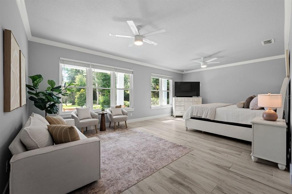 A modern single-story house with a covered front porch and a concrete walkway at sunset — 590 LAKE WINNEMISSETT DRIVE, DELAND, FL