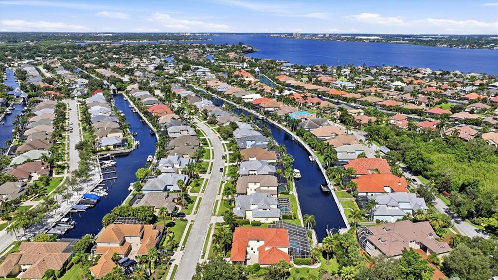 An aerial view of a residential neighborhood featuring houses situated along multiple man-made canals — 4747 PINNACLE DRIVE, BRADENTON, FL