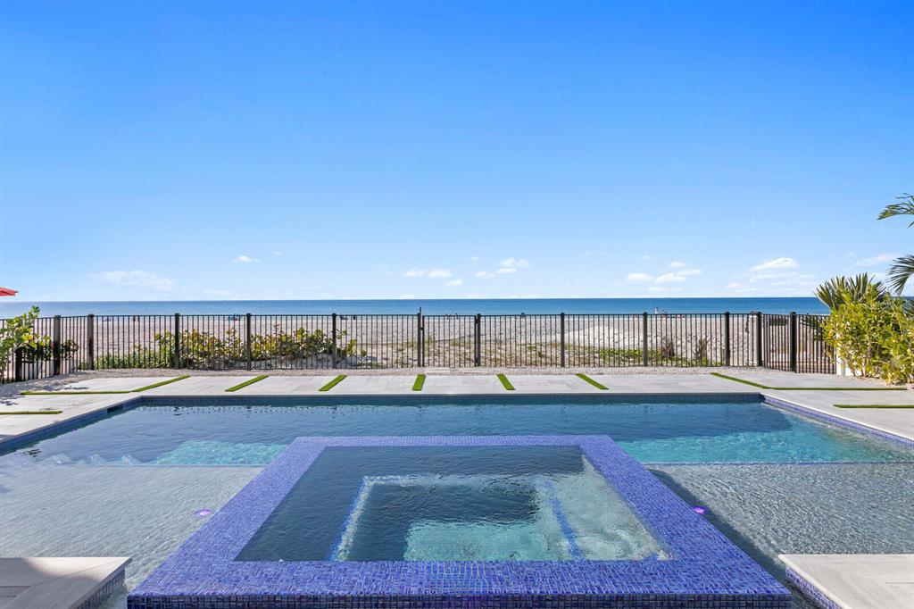 A swimming pool and tiled spa overlook a sandy beach and the ocean — 70 GULF BOULEVARD, INDIAN ROCKS BEACH, FL