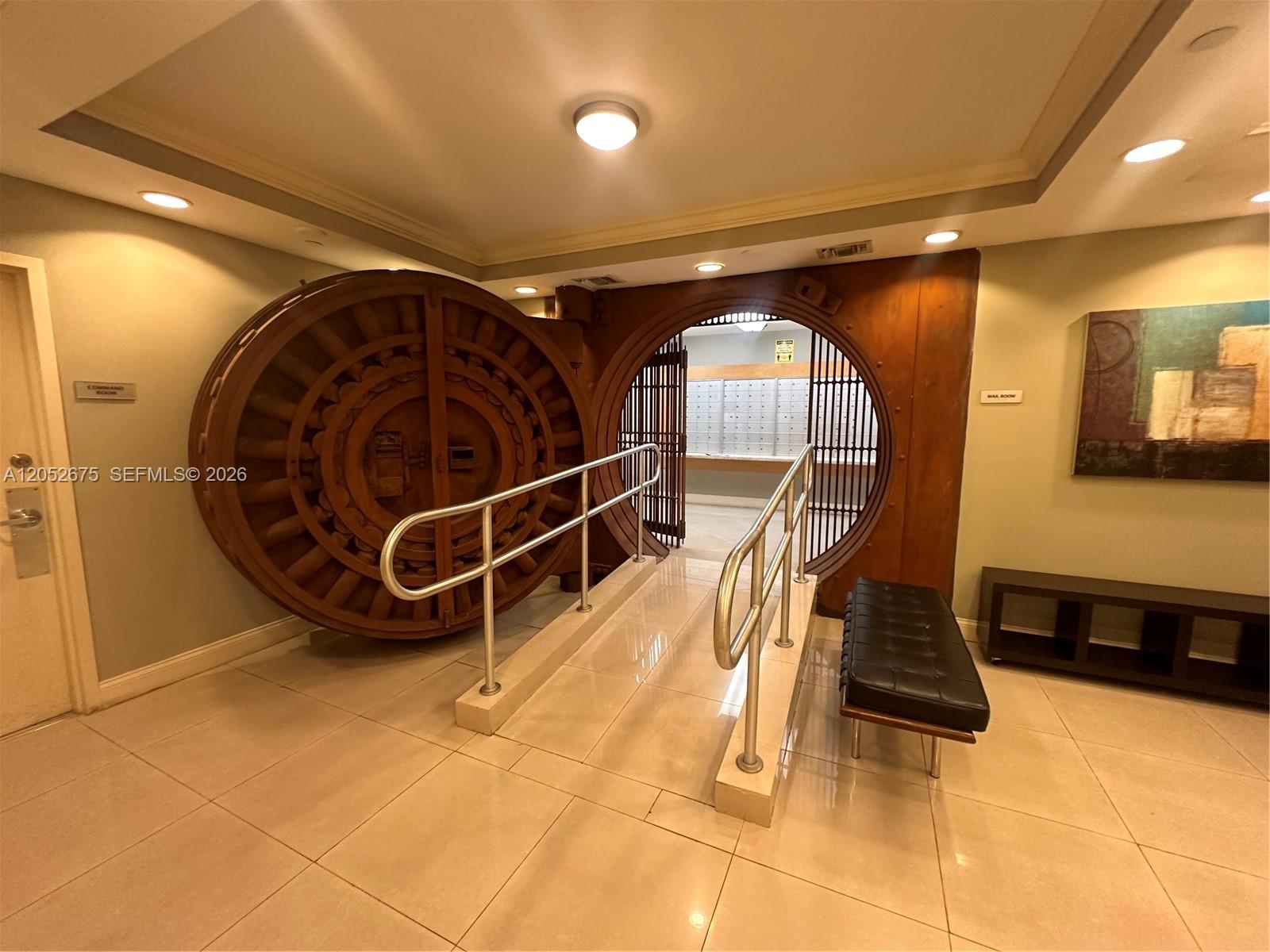 A large circular bank vault door serves as the entrance to a mail room — 111 E Flagler St # 410, Miami FL 33131, MIAMI, FL