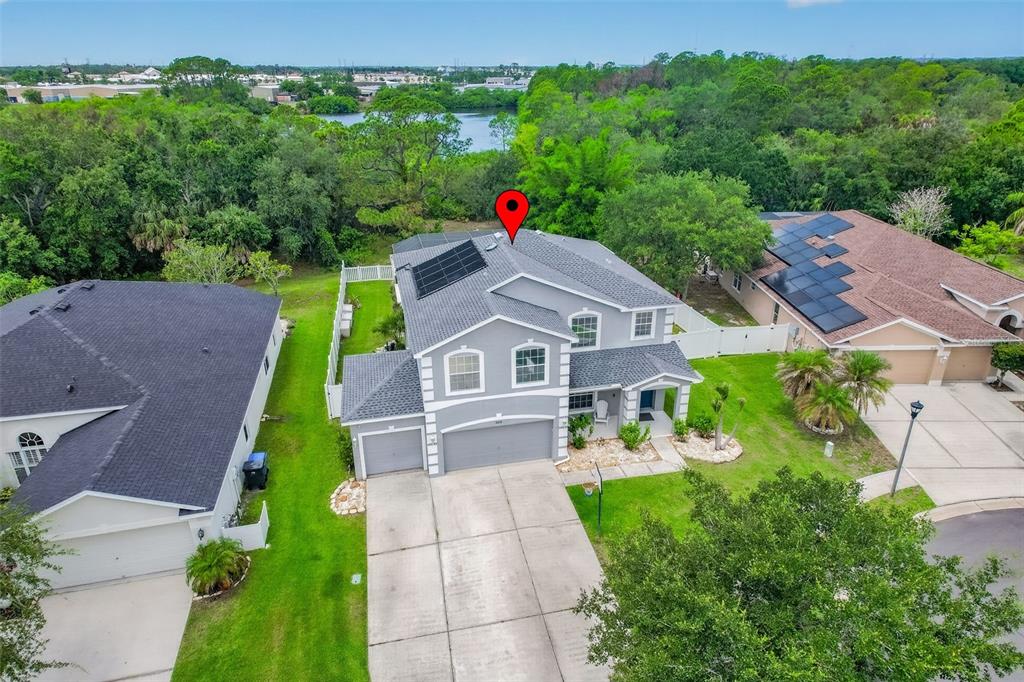 A two-story gray house with white trim, a double garage, and a basketball hoop — 9018 N RIVER ROAD, TAMPA, FL