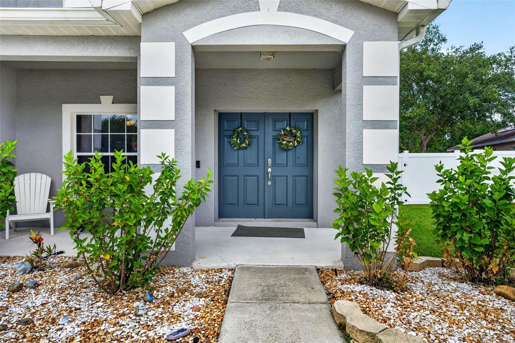 An aerial view shows a two-story gray house with solar panels and a concrete driveway — 9018 N RIVER ROAD, TAMPA, FL