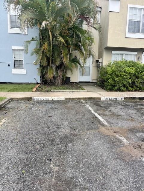 An exterior view shows two townhomes with reserved parking spaces in the foreground — 6600 121ST AVENUE UNIT 6, LARGO, FL