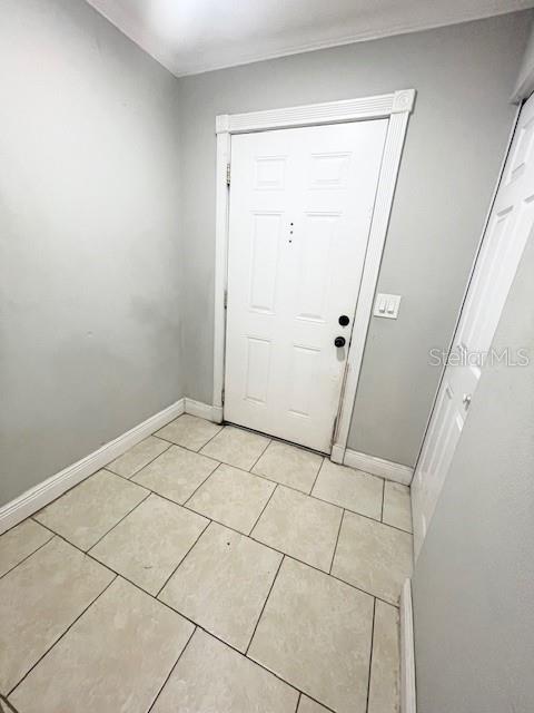 An entryway features light-colored tile flooring, gray walls, a white front door, and a closet — 6600 121ST AVENUE UNIT 6, LARGO, FL