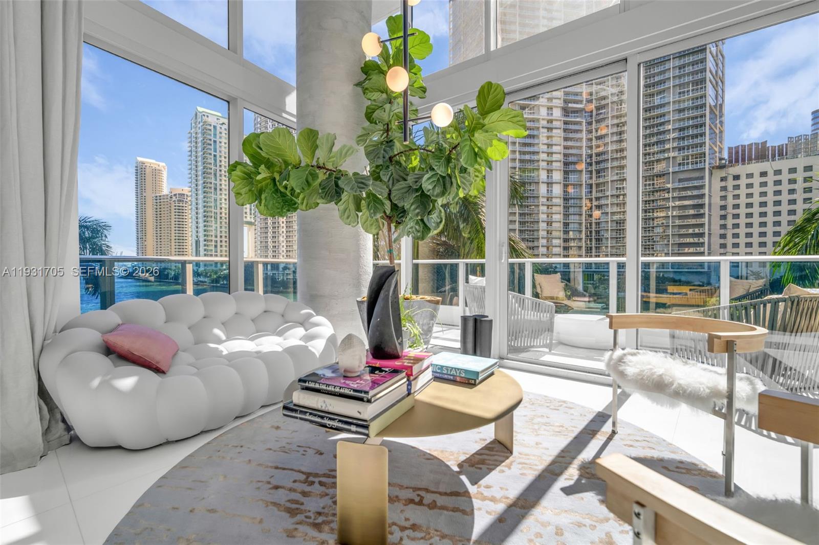 A bright living room features a white bubble sofa, coffee table, and floor-to-ceiling windows — 200 Biscayne Boulevard Way # 309, Miami FL 33131, MIAMI, FL