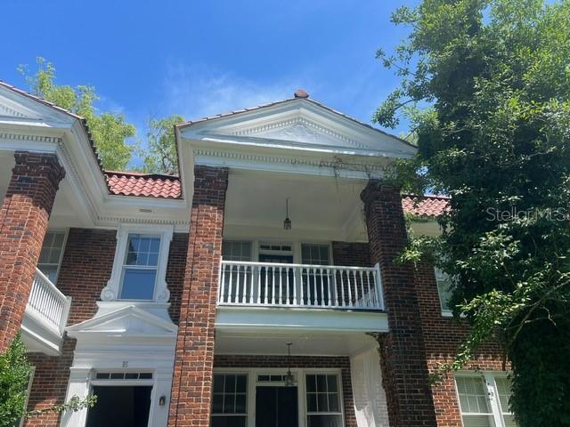 A two-story brick building features a white pediment, a second-story balcony, and a tiled roof — 1975 VINEVILLE AVENUE UNIT F3, MACON, GA