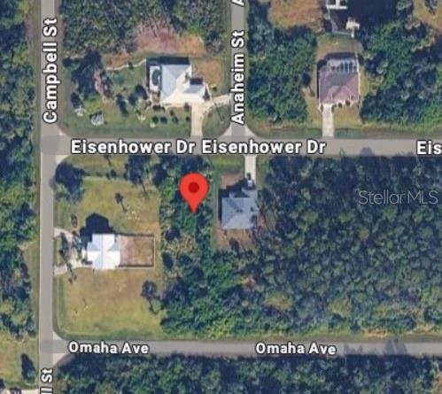 This is an aerial map view of a vacant residential lot marked with a red pin — 12037 EISENHOWER DRIVE, PORT CHARLOTTE, FL