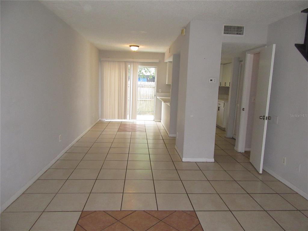 A tiled dining area leads to a sliding glass door opening onto a fenced patio — 13050 N 20TH STREET, TAMPA, FL