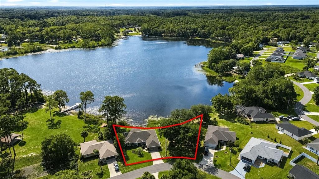 An aerial view shows a house with a red outline on a lakefront lot — 1081 NE 130TH TERRACE, SILVER SPRINGS, FL