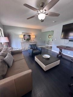 A living room features a brown sofa, a dark armchair, and a square coffee table — FORT LAUDERDALE, FL