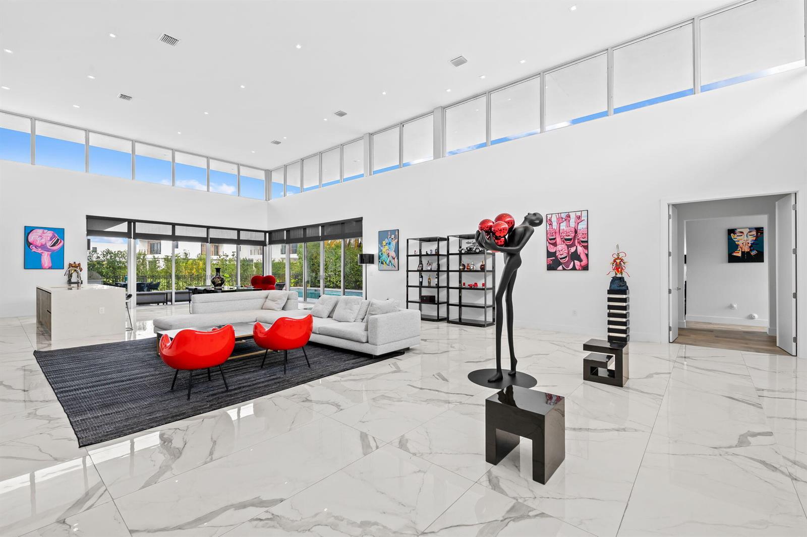 A spacious, modern living room with white marble floors, high ceilings, and large glass windows — 16758 Natures Way, Weston FL 33326, WESTON, FL