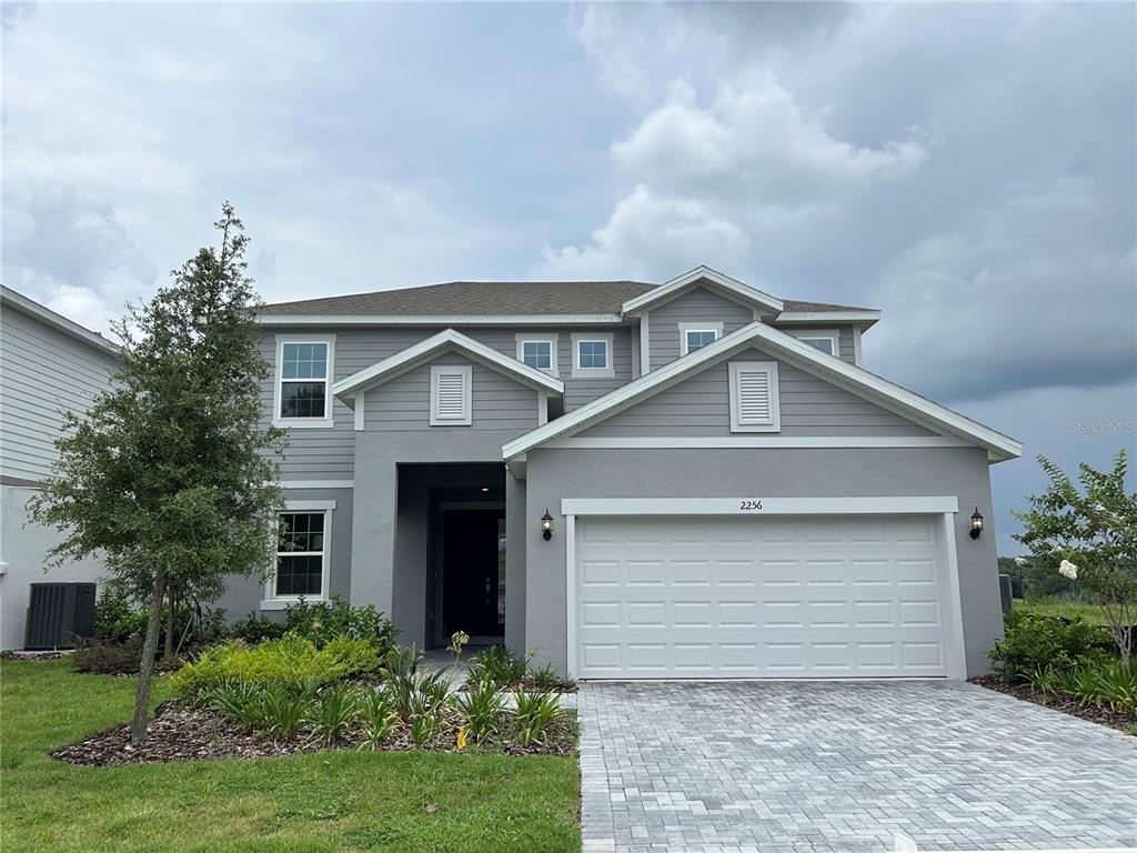 A two-story gray house with a two-car garage and a paved driveway — 2256 SIRENA LANE, MOUNT DORA, FL