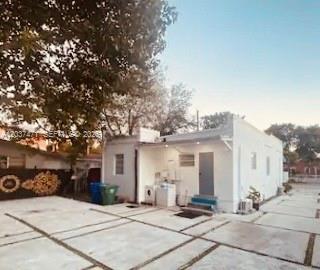 A white single-story house with a paved driveway and a large tree in the yard — 1145 NW 28th St # B, Miami FL 33127, MIAMI, FL