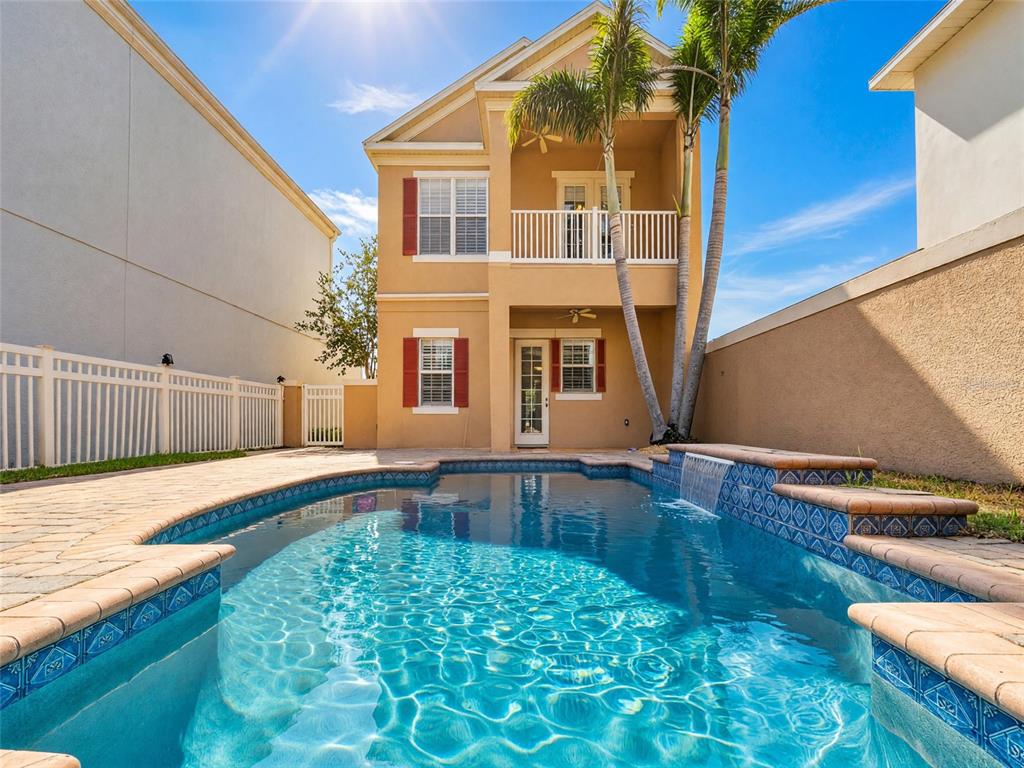 A two-story house with a swimming pool and a waterfall feature in the backyard — 7526 EXCITEMENT DRIVE, REUNION, FL