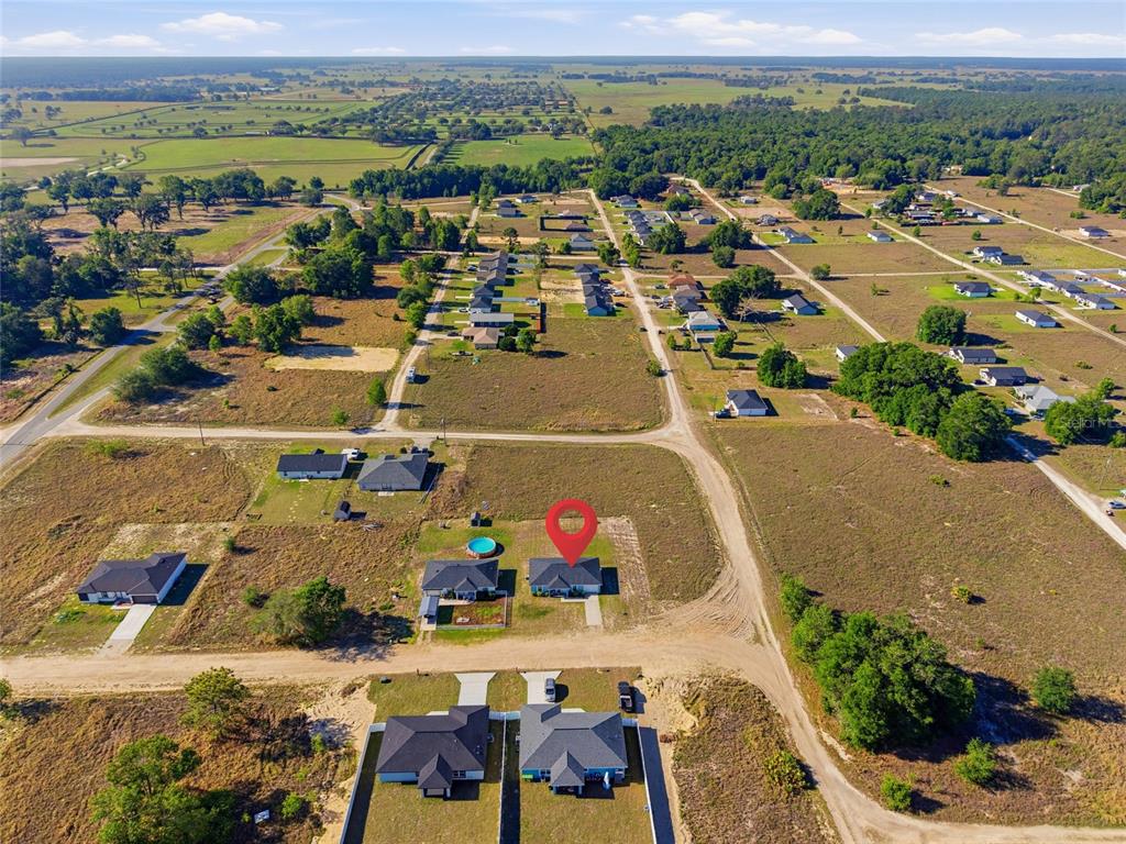 An aerial view shows a single-family home with a red location pin in a rural subdivision — 14960 SW 33RD LANE, OCALA, FL