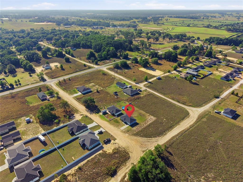 An aerial view shows a single-family home with a red location pin in a rural area — 14960 SW 33RD LANE, OCALA, FL