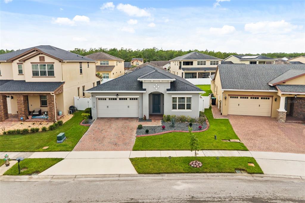 A single-story suburban house with a gray exterior, a two-car garage, and a paved driveway — 3118 RESIDENCE EAST WAY, ORLANDO, FL