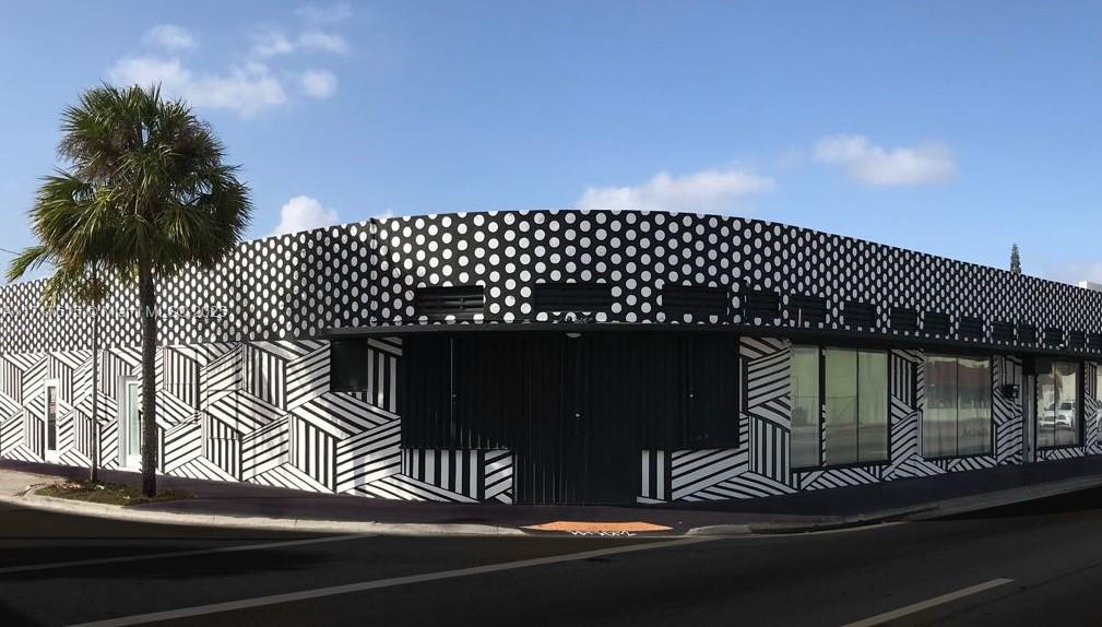 A corner building exterior features a black and white polka dot pattern and geometric stripes — 5600 NW 7th Ave, Miami FL 33127, MIAMI, FL