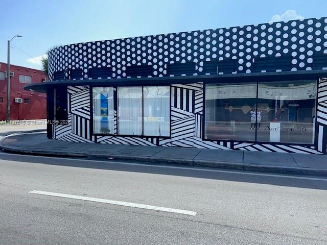 A commercial building exterior features a black and white polka dot and striped facade — 5600 NW 7th Ave, Miami FL 33127, MIAMI, FL